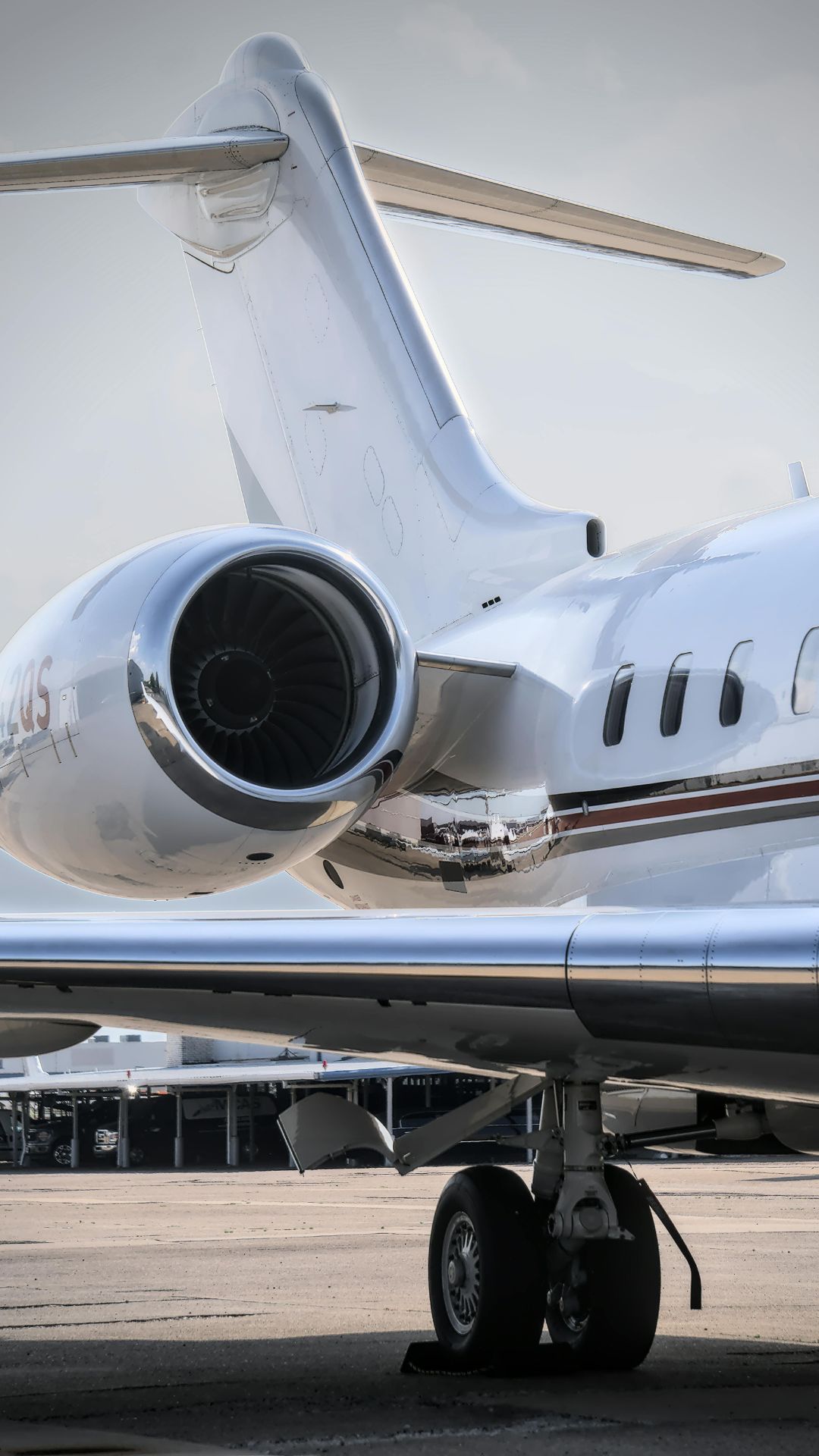 Close-up view of a private jet engine on an airport tarmac, illustrating the worldwide private, commercial and cargo charter capabilities offered by IONA JETS.